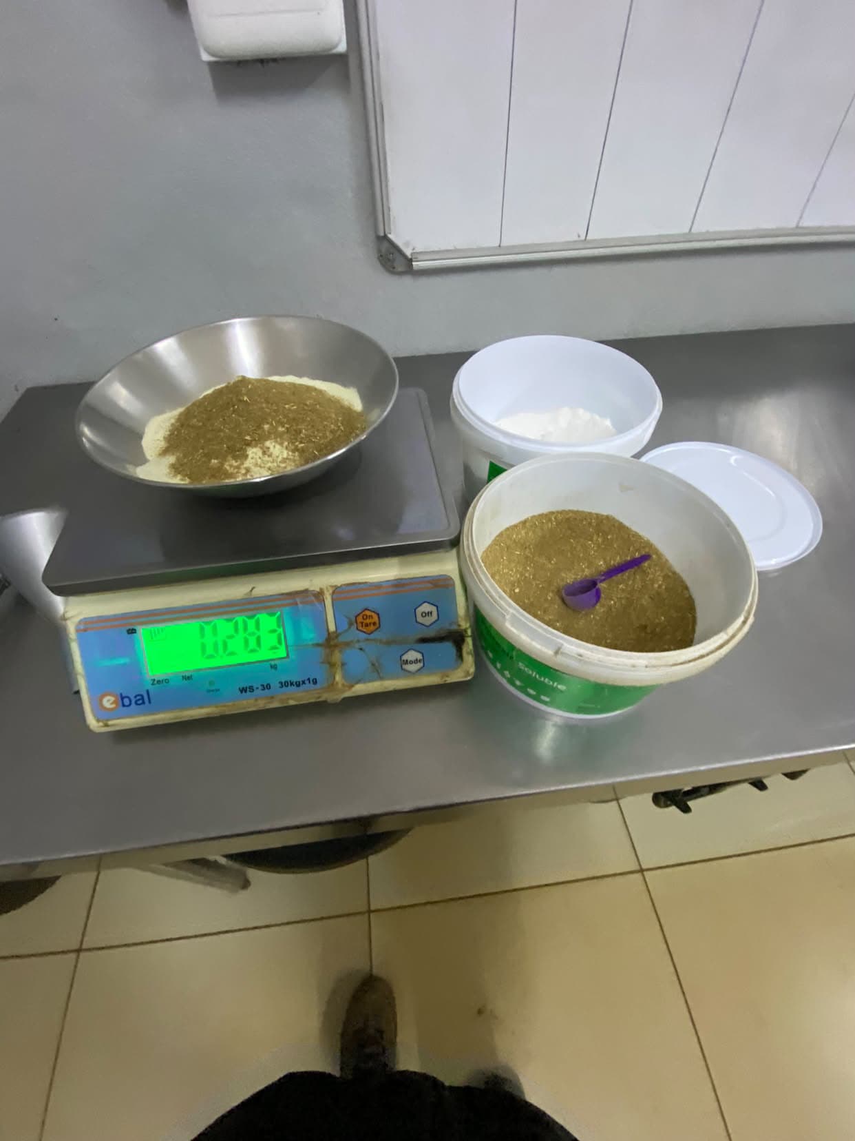 Rhino formula and pellet dust being weighed on a scale to prepare milk