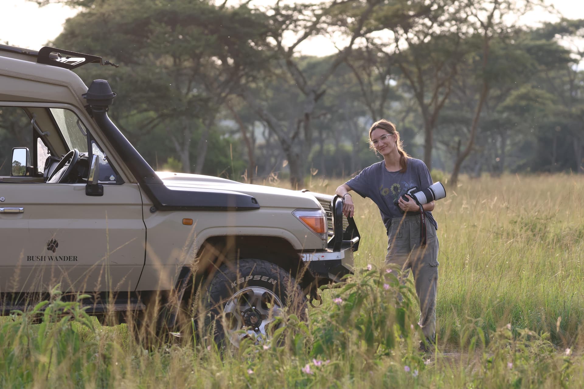 A wildlife photographer out in the field with her camera