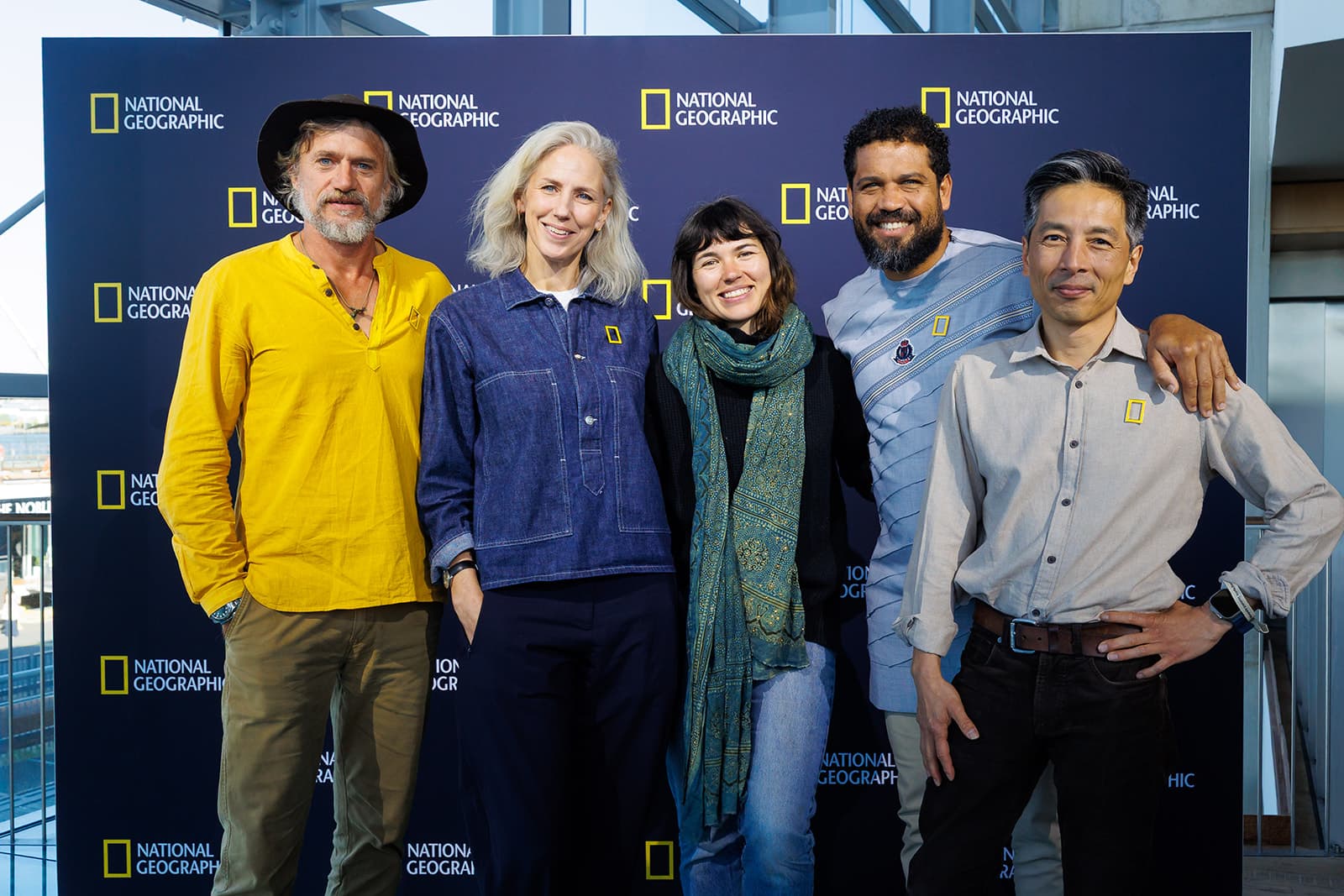 Sophie Darlington with National Geographic storytellers in front of a National Geographic backdrop